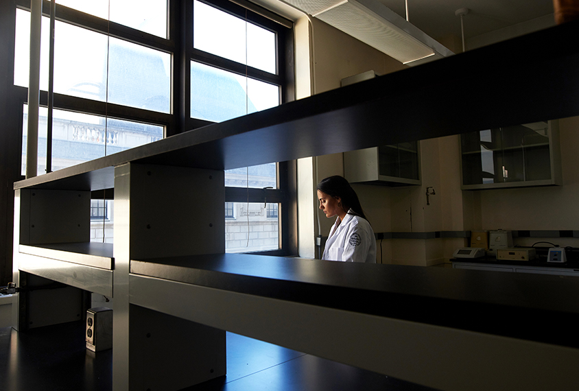 Constantina Theofanopoulou stands by a large window in her lab.